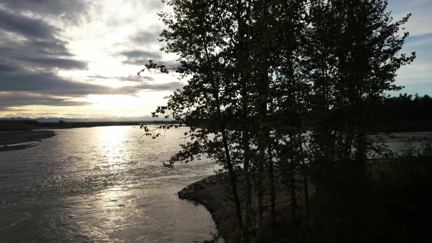 Aerial Track By Trees Reveal View Of Denali With Dramatic Sunset