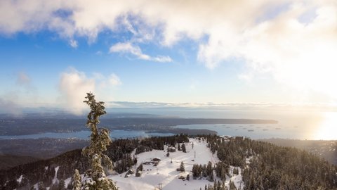 Cinemagraph Loop Animation. Panoramic View of Top of Grouse Mountain Ski Resort with the City in the background. North Vancouver, British Columbia, Canada. Sunset Sky