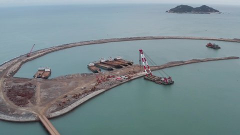 Sanya , Hainan island , China - 02 09 2022: Land reclamation. Construction ships moored and anchored and artificial island building site in Hainan, China.