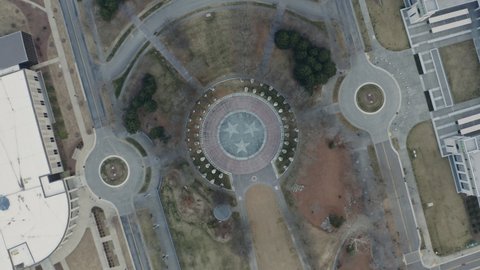 Spinning aerial view over Tri-Star Tennessee state seal in Nashville, 4K