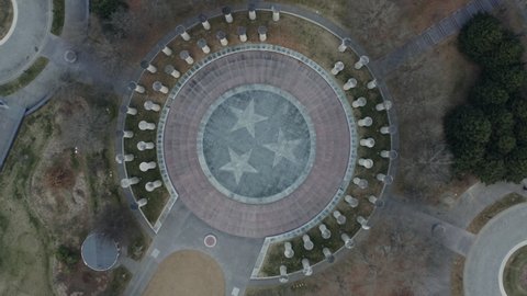 Aerial spiraling up and away from Tri-Star Tennessee state emblem in park, 4K