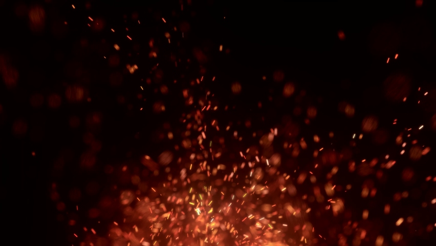 Flying Embers from fire. Closeup of burning hot bonfire fire sparks. Fire Particles over black background with smoke.  | Shutterstock HD Video #1087460732