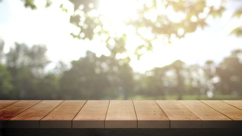 Wood table bar in summer day, and nature background green tree bokeh blurred animated and sun light. (4k3840x2160p29,97fps)