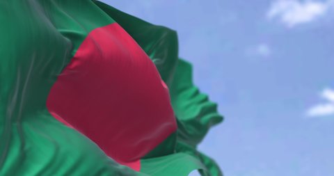 Detail of the national flag of Bangladesh waving in the wind on a clear day. is a country in South Asia. It is the eighth-most populous country in the world. Selective focus. Seamless looping in slow 