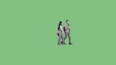 A young man and a woman walk together and talk. Green screen clip with transparent bacground