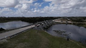 Aerial view if the S12A Spillway video shows a rising view to capture the entire dam in fluid motion. SW 8th St, Ochopee, FL 34141 USA February 20th 2022.