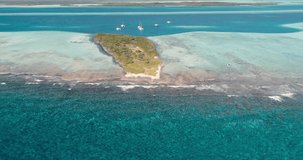 Travelling Over Shallow Coral Reef Barrier Near Sailboats in Los Roques