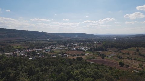Aerial footage towards farmlands and a town with a fantastic landscape near Wat Somdet in Phu Ruea, Ming Mueang, Loei in Thailand.