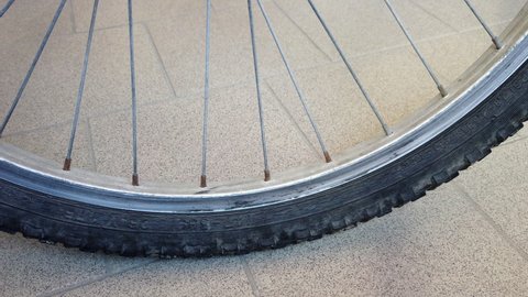Part of a bicycle wheel with spokes tread and a close angle and shallow depth of field
