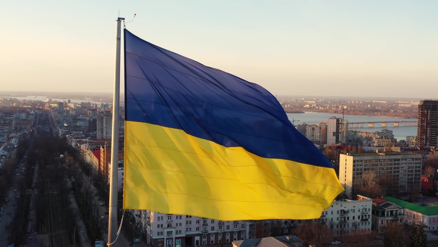 Flag of Ukraine against the backdrop of sunrise. Yellow-blue flag of Ukraine wind waving. Ukraine National symbol.
 | Shutterstock HD Video #1087498970