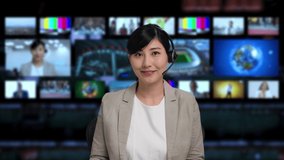 Asian announcer appearing on news program.