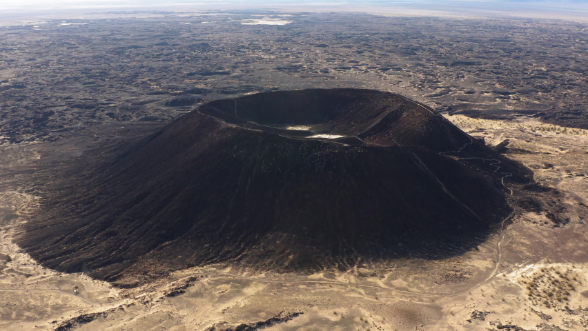 Cinematic Aerial view of Amboy Crater dormant volcano in the Mojave Desert of southern California. Drone natural landscape of popular travel destination for Route 66 adventurer