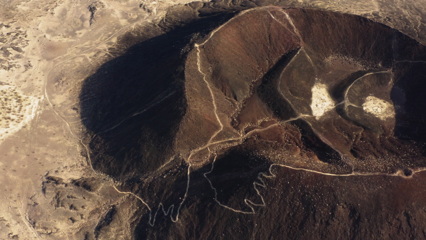 Cinematic aerial landscape of Amboy crater in Mojave desert southern California, drone fly above the dormant volcano exploring remote unpolluted Mother Earth beauty 