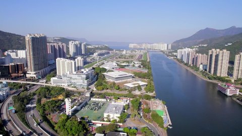 Beautiful high-rise apartments next to the Shing Mun River and the Shatin racecourse and green nature in one of the modern districts of Hong Kong. Drone pedestal shot