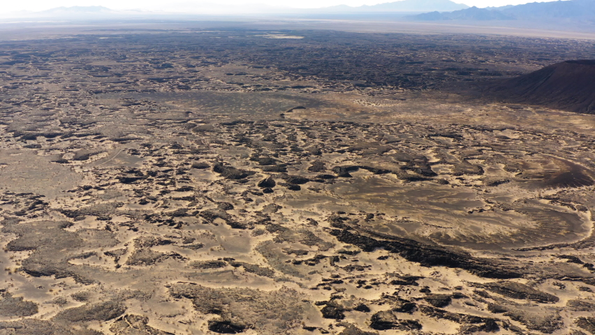 Aerial cinematic panoramic view of Amboy Crater lava field Mojave Desert of southern California, drone reveal scenic natural unpolluted landscape on the famous Route 66 USA