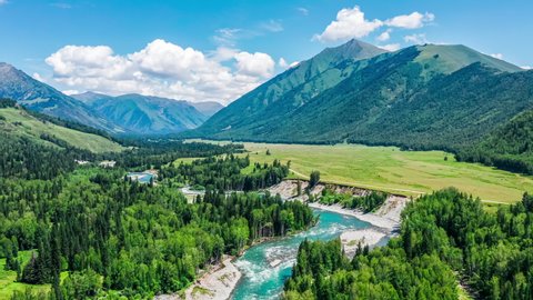 Aerial footage of mountain and river with green forest natural landscape in Xinjiang, China. Green nature landscape in summer season.