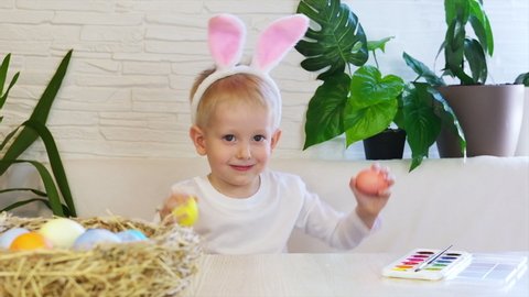 Funny happy child boy with easter eggs and bunny ears dancing. Easter concept, happy childhood. Easter Egg Hunt. Slow motion.
