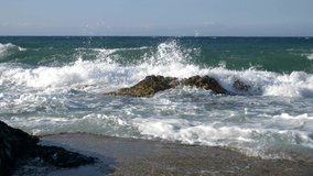 Sea waves crash on the rocks. Slow motion 4K