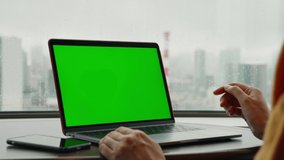 People using a laptop PC in the room. Green screen for chroma key composition. - Powered by Shutterstock - Get 15% off with code: PIKWIZARD15