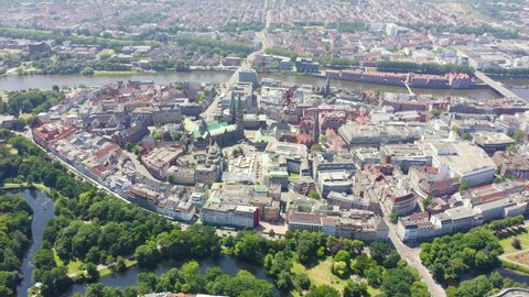Inscription on video. Bremen, Germany. The historic part of Bremen, the old town. Bremen Cathedral ( St. Petri Dom Bremen ). View in flight. Appears from the sand, Aerial View, Departure of the camer