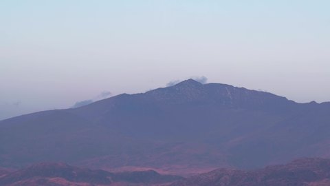 Long telephoto landscape view of Snowdon mountain in Snowdonia at blue hour