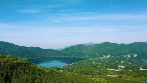 Cinematic revealing drone shot of a lake in Hakone , Japan