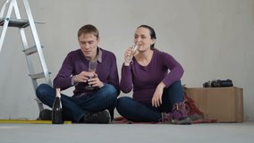 Cheerful Man and Woman Enjoying Relocation. Young Couple Drinking Champagne while Celebrating Buying New House, Discussing Future Renovation - Powered by Shutterstock - Get 15% off with code: PIKWIZARD15