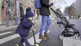 Child and mother crossing street on crosswalk. Kid riding scooter with parent - Powered by Shutterstock - Get 15% off with code: PIKWIZARD15