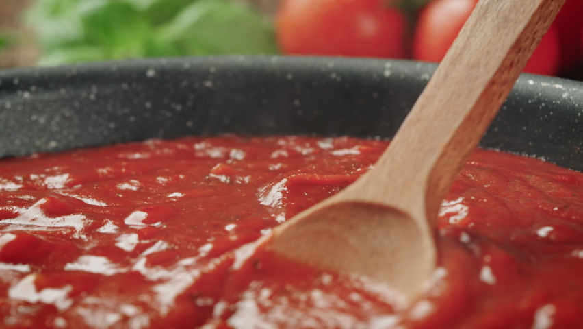 Stirring Tomato Sauce for Spaghetti or Pizza with Wooden Spoon - Zoom Out | Shutterstock HD Video #1087531394
