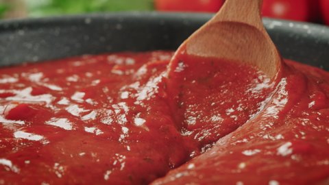 Стоковое видео: Stirring Tomato Sauce for Spaghetti or Pizza with Wooden Spoon - Zoom Out