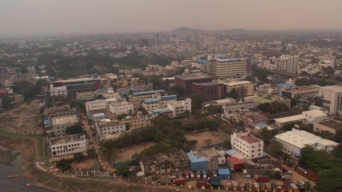 Aerial shot of Cooum River surrounded by buildings in the late evening in Chennai India.