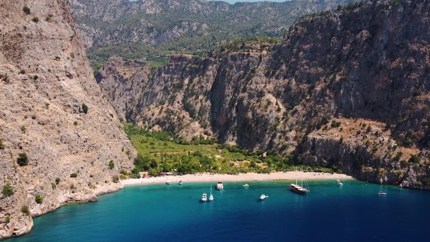 Aerial dolly shot approaching paradisiacal sandy beach in Turkey.