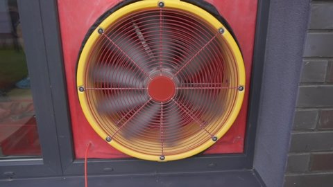 Energy audit with blower door test fan for specialized services sites. Gimbal slow motion shot