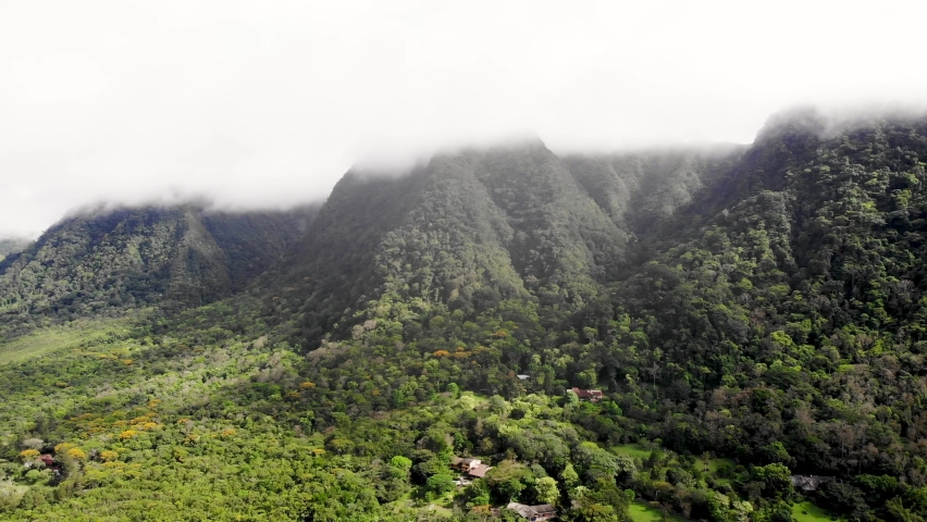 Valle de Anton cloudy volcanic crater wall covered by forest in central Panama, Aerial dolly out shot