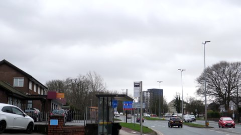SALFORD, GREATER MANCHESTER, ENGLAND, UNITED KINGDOM - CIRCA FEBRUARY, 2022: Car windscreen view driving in Eccles town past road direction, city boundary and road improvement scheme signs.