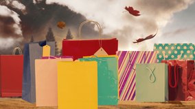 Animation of autumn leaves falling over presents bags. autumn and shopping concept digitally generated video.