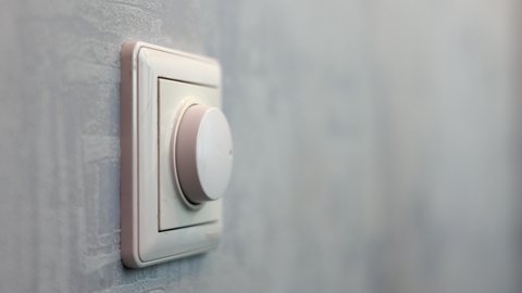 Male Hand Close-up Turns The Dimmer Switch Off The Light Switch