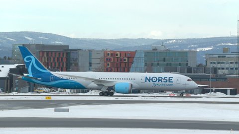 Oslo Airport Norway - February 23 2022: airplane boeing 787 dreamliner norse atlantic airlines taxiing on ground winter light