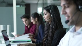 Diverse group of indian woman employees are making calls using headsets and laptops working in call center busy with communication and customer support customer service help desk online. - Powered by Shutterstock - Get 15% off with code: PIKWIZARD15