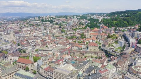 Inscription on video. Lausanne, Switzerland. Flight over the central part of the city. La Cite is a district historical centre. Appears from the sand, Aerial View, Departure of the camera