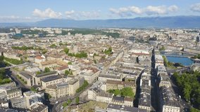 Inscription on video. Geneva, Switzerland. Flying over the central part of the city in the morning hours. Arises from blue water, Aerial View