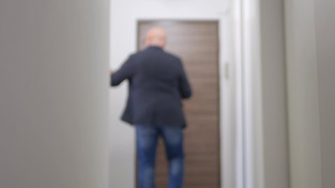 Person Leaving the Apartment and Turning Off the Lights One by One. Businessman Leaving the Office and Closing the Lights.