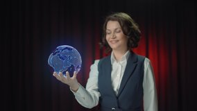 A business woman holds a three-dimensional 3D hologram of the planet Earth on her hand. The space object unwinds and the woman throws it up. After that, she throws up her hands. Funny video. - Powered by Shutterstock - Get 15% off with code: PIKWIZARD15