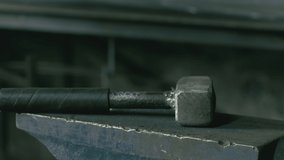 Forge workshop. Smithy manual production. Hands of smith with hammer hit on glowing hot metal, on the anvil, the forging process. Blacksmith makes iron products for manufacture of fireplace, stove. - Powered by Shutterstock - Get 15% off with code: PIKWIZARD15