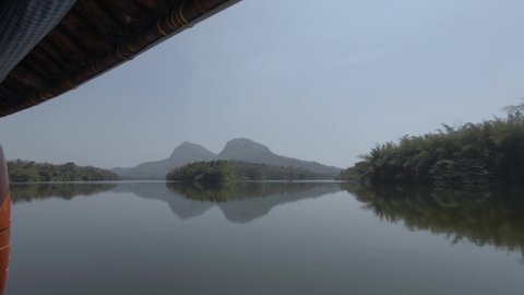 Boat ride through the calm waters of river Periyar during the day in Kerala, India.