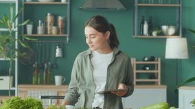 Young Woman Drinks Smoothies, Makes a Meal Plan on the Tablet in the Kitchen, Using the Calorie Counter in the App. Organic Foods, Low-calorie Diet For Weight Loss. Nutrition and Dietetics. - Powered by Shutterstock - Get 15% off with code: PIKWIZARD15