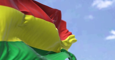 Detail of the national flag of Bolivia waving in the wind on a clear day. Bolivia is a landlocked country located in western-central South America. Patriotism. Selective focus. Seamless slow motion