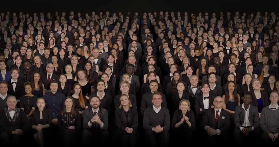 Front view of spectators wearing formal attire delivering standing ovations. Crowd background for theater, opera, ballet Royalty-Free Stock Footage #1087580687