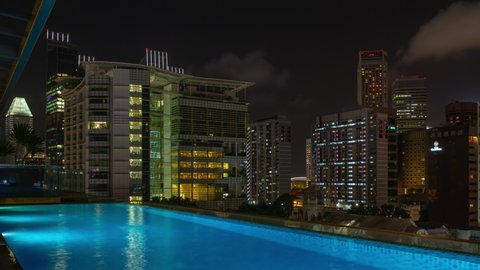 night time singapore city downtown library famous luxury rooftop swimming pool timelapse view 4k