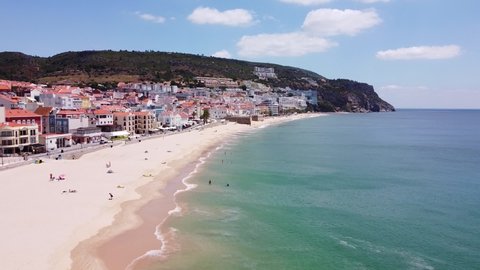 Praia da California Beach at Sesimbra, Alentejo, Portugal - Aerial Drone View of the Boulevard with Popular Sandy Beach, Tourists, Restaurants and Hotels